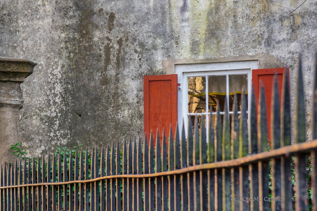 Red Shutters and Wrought Iron