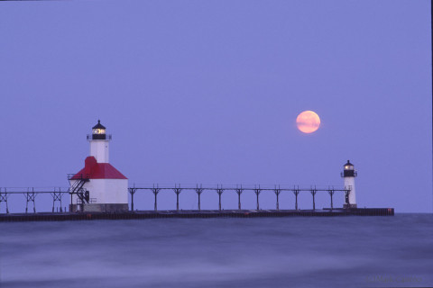 Lighthouse at St. Joseph, Michigan with full moon setting behind.